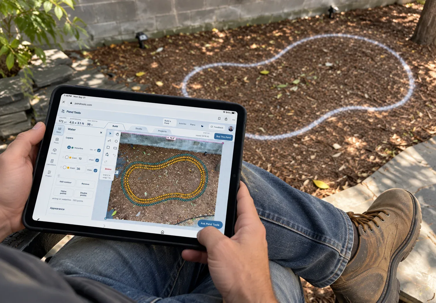 A contractor sitting in a yard with a tablet, a pond outline traced over the ground and marked in chalk